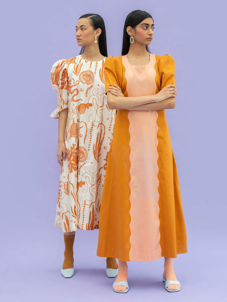Little Things Studio offers this beautiful sustainable dress in an orange and peach colorblock