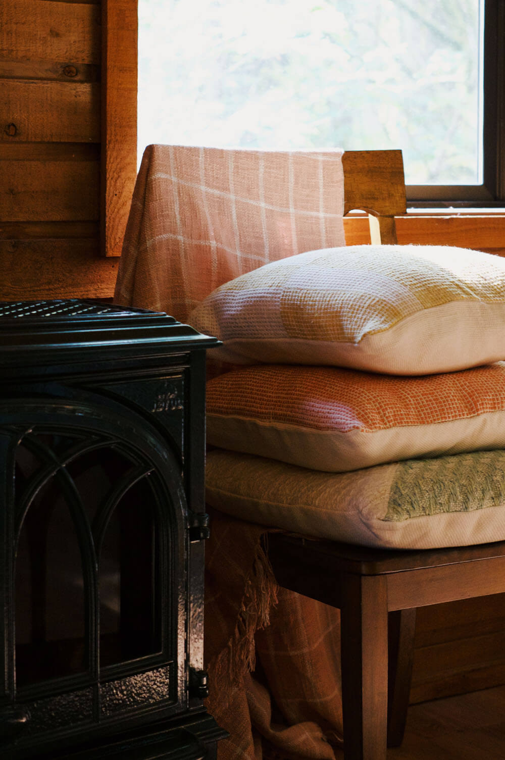 stack of handwoven pillows in airbnb cabin