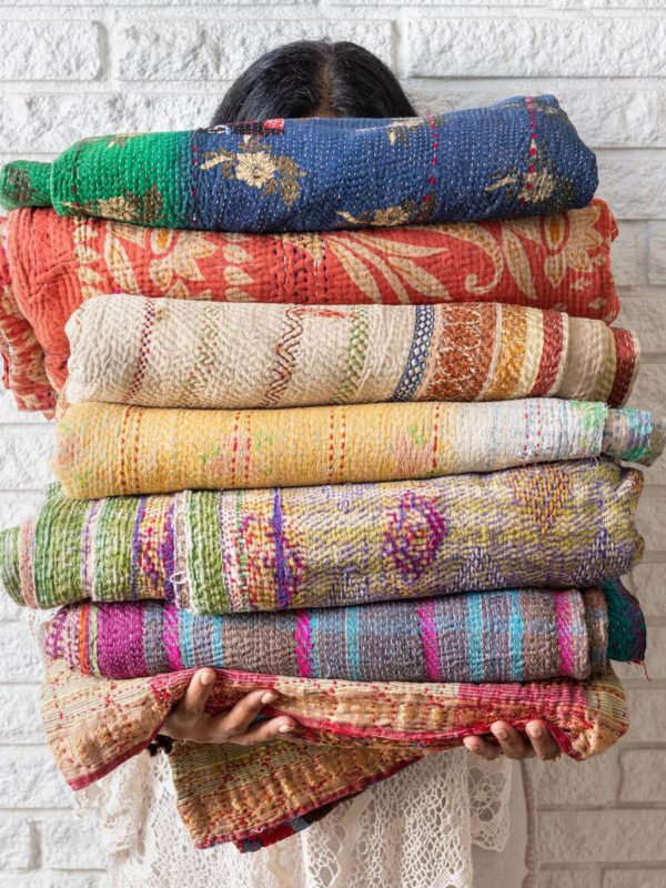 stack of colorful throw blankets by eco club sustainable directory member TRIBE