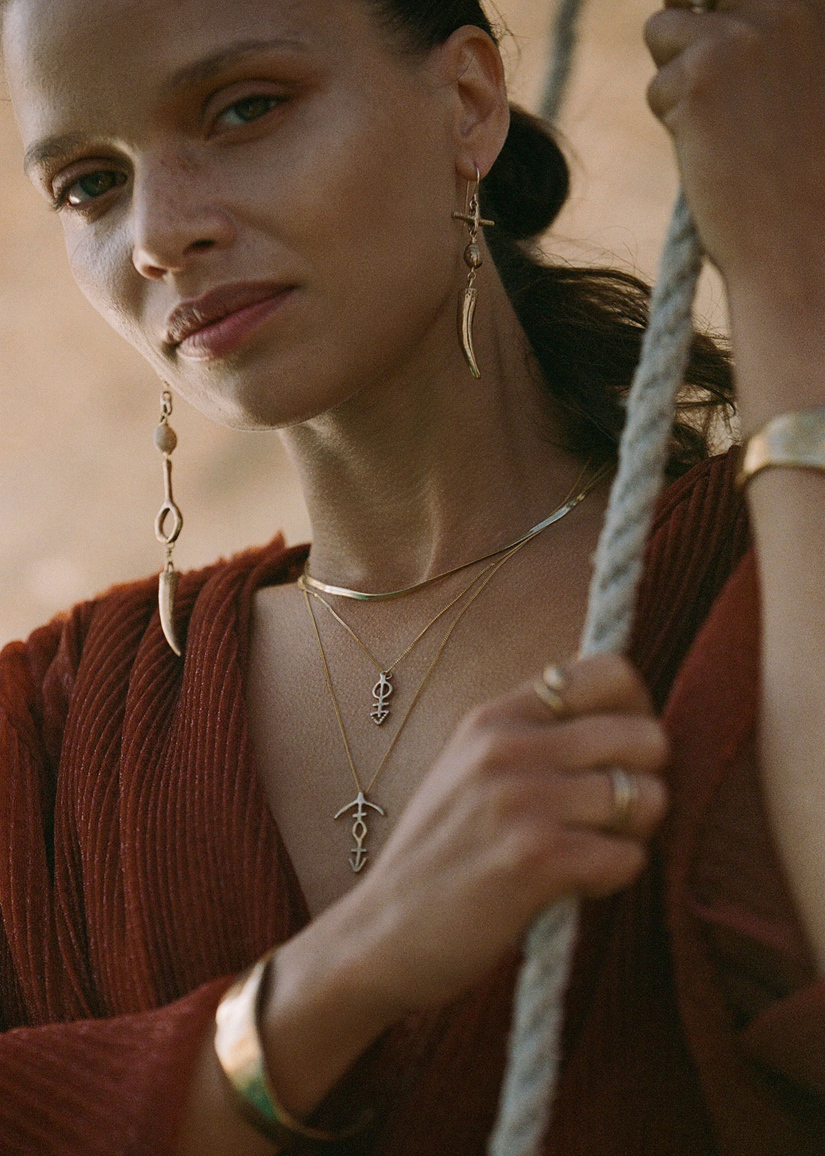 woman wearing gold catori life recycled and bohemian jewelry in eco club directory