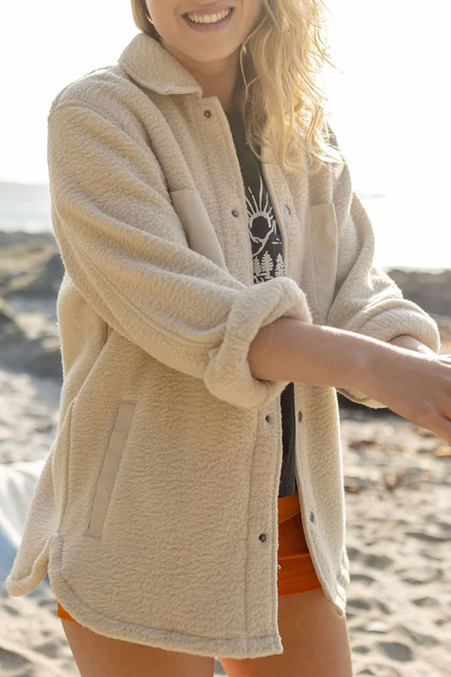 woman in cream colored fleece recycled sherpa shacket