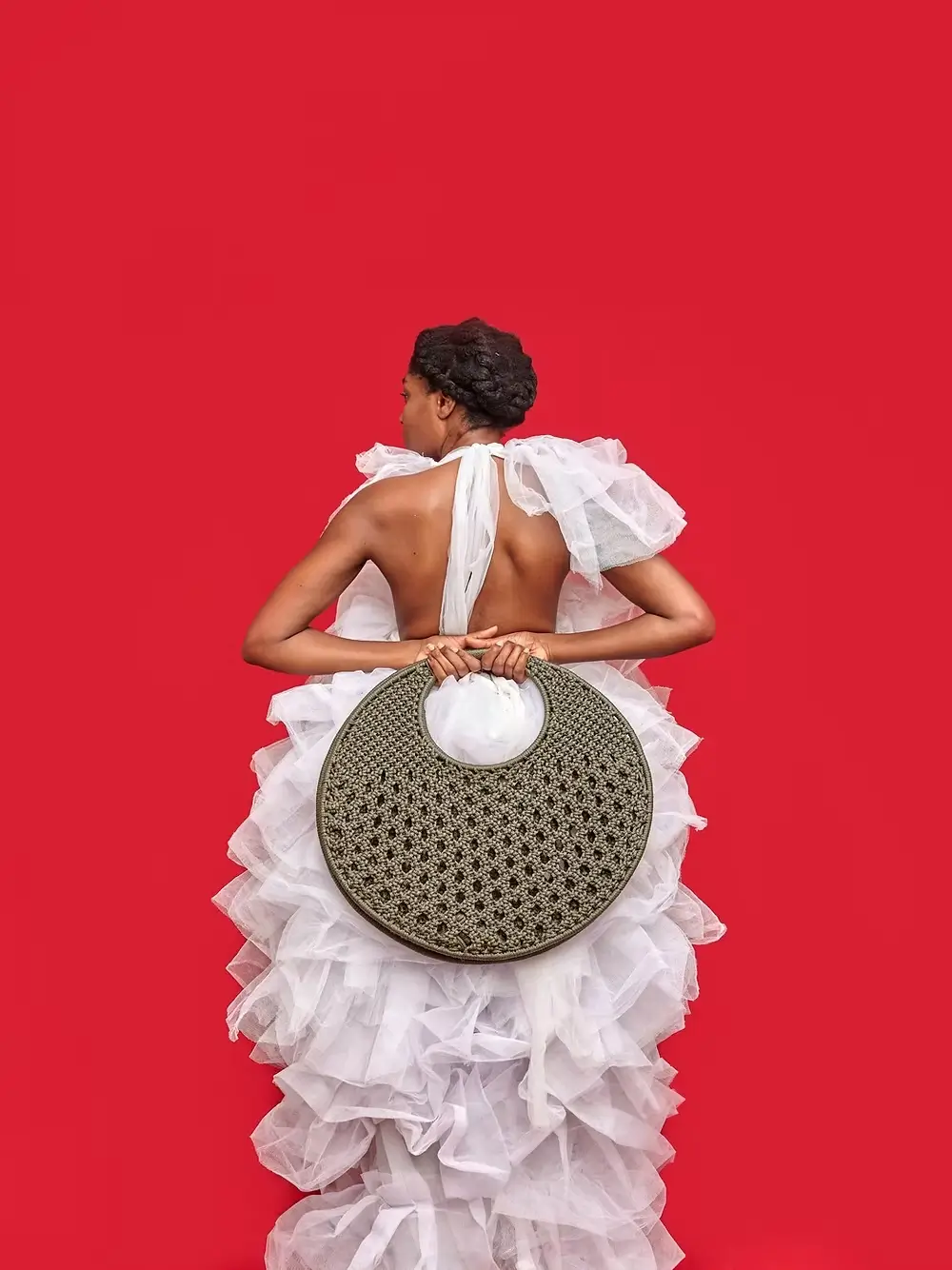 woman wearing white with oversized African handbag by Vanhu Vamwe