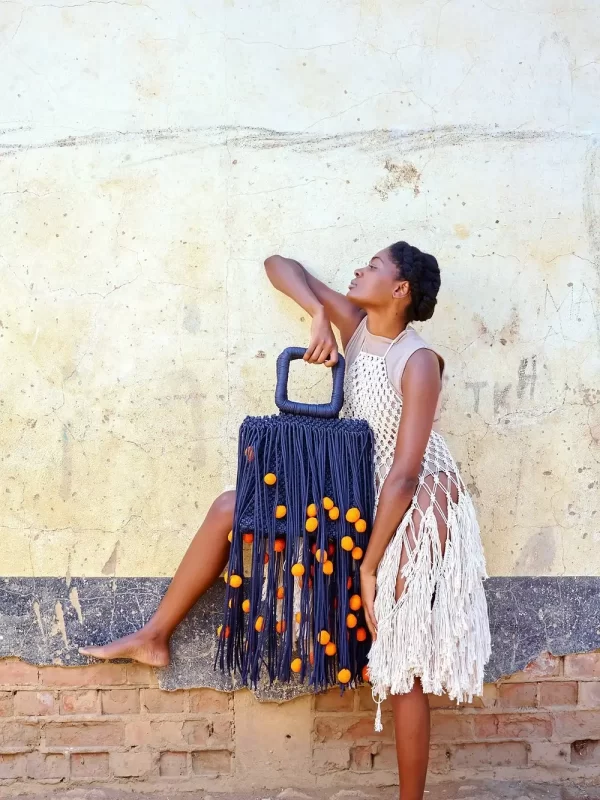 woman wearing white with oversized African macrame bags by Vanhu Vamwe