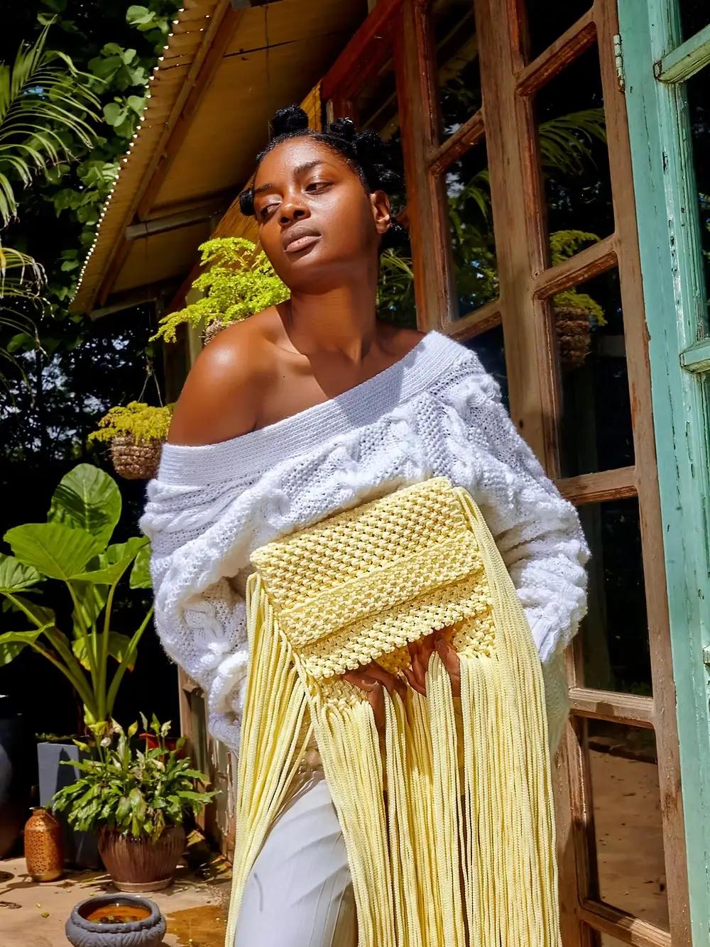 woman carrying yellow macrame crochet African bag