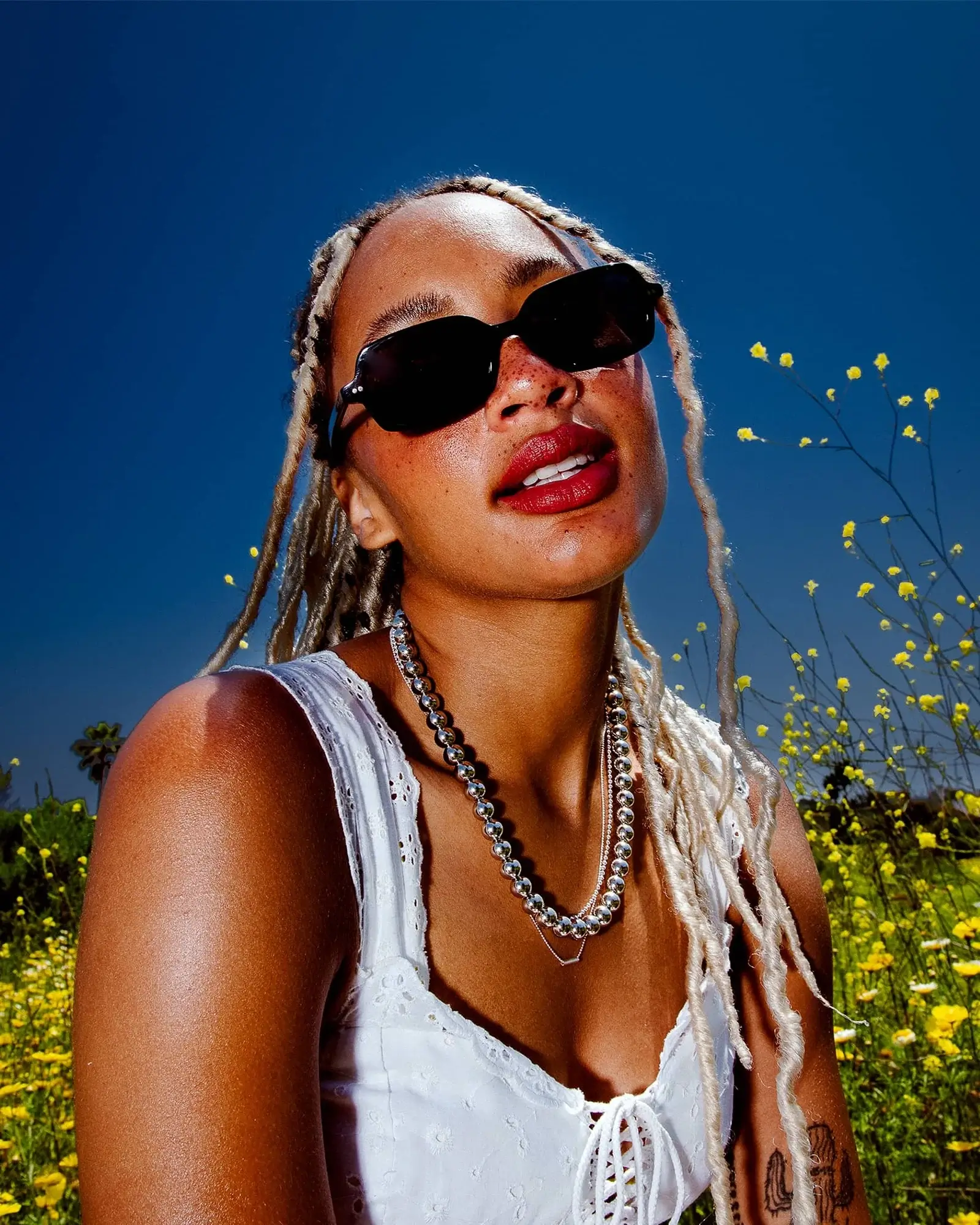 woman wearing unisex acetate sunglasses by crap eyewear