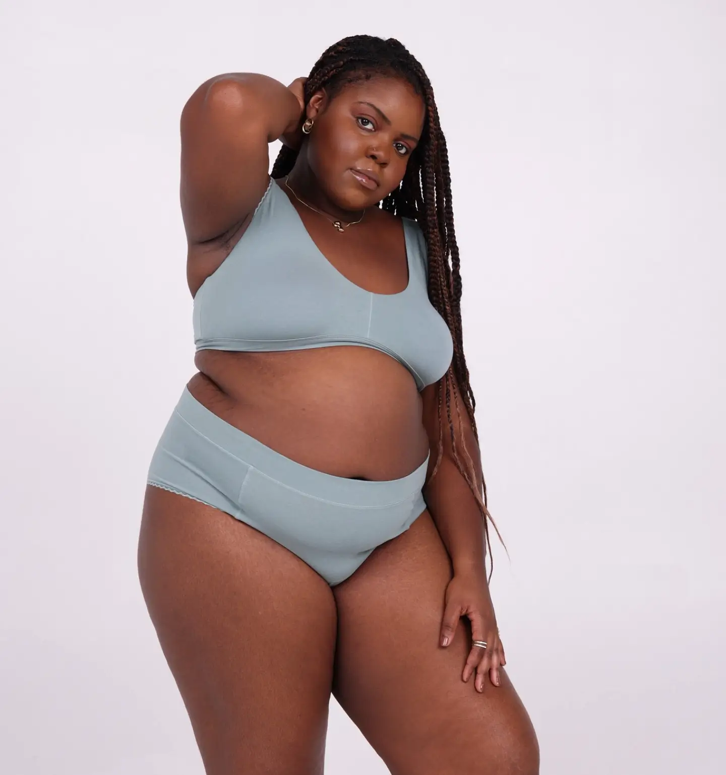 black woman wearing blue organic cotton underwear & bra from La Coochie - size inclusive undies