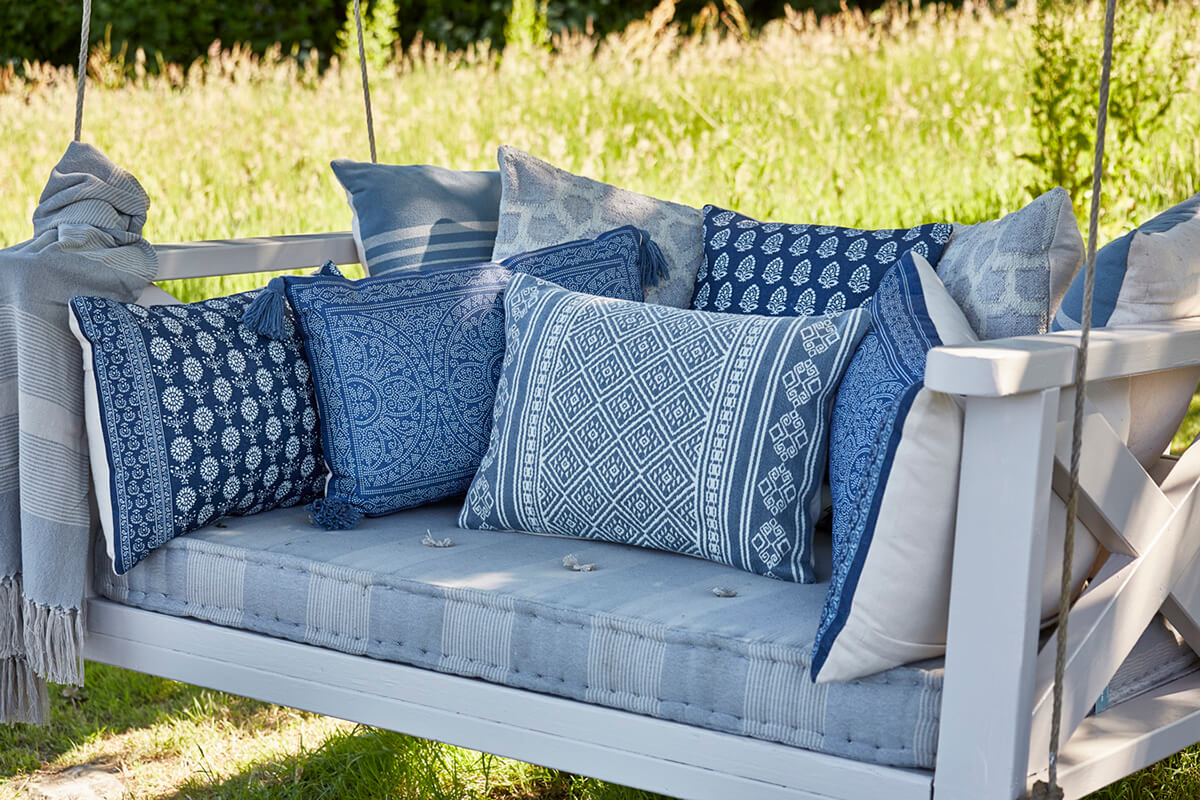 Blue printed pillows on outdoor swing from Weaver Green