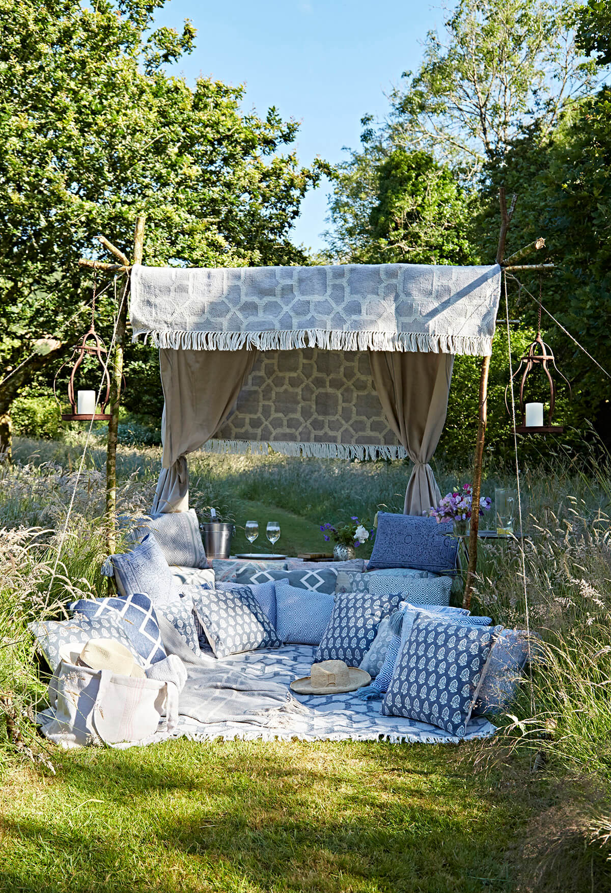 glamping picnic idea with blue pillows and rugs from Weaver Green