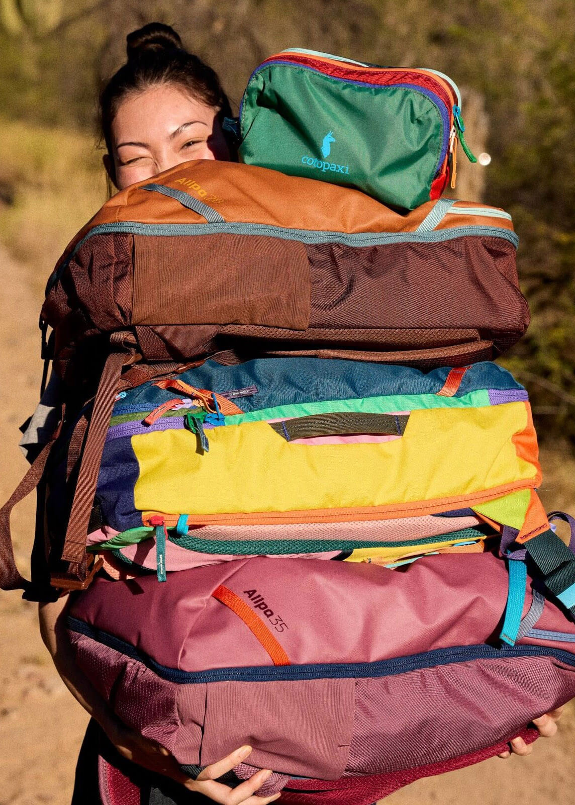 Colorful stack of recycled backpacks by sustainable brand Cotopaxi