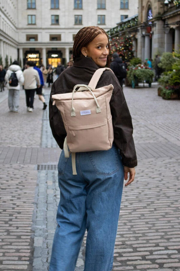 Woman wearing sustainable Kind Bag London recycled backpack
